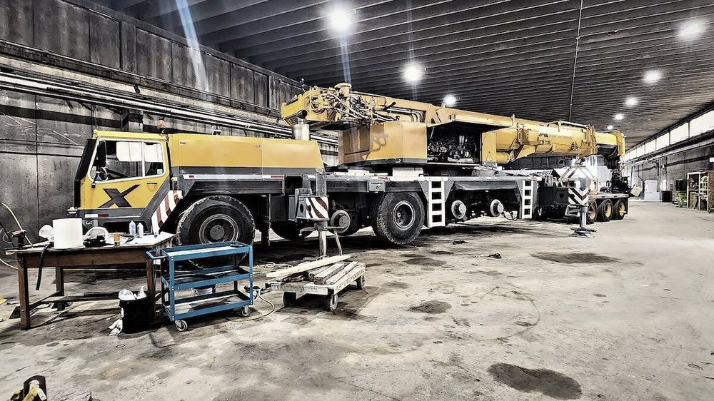 Five-axle all-terrain mobile crane inside the Mach 6 shop bay