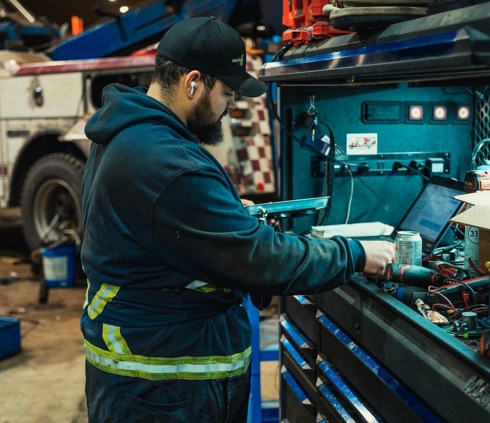 Mach 6 technician running electrical diagnostics at a shop toolbox